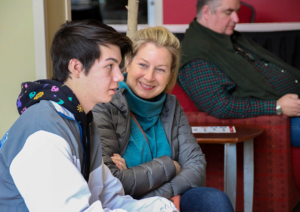 mom and son at open house, mom looks at son expectantly